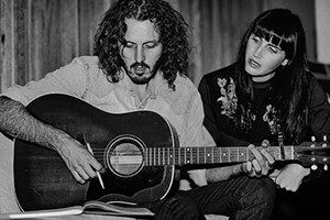 A black and white photo of Falls Band playing guitar