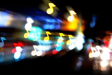 Colourful music notes projected out of a lighting fixuture