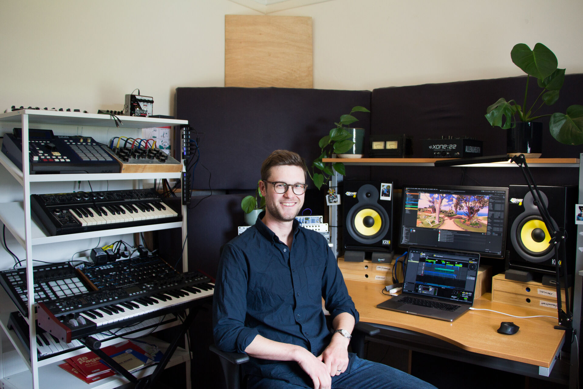 Ben Houghton is sitting in a studio, facing the camera and smiling. He is wearing a dark shirt and jeans.