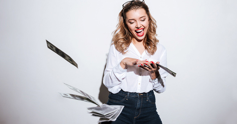 Girl in a white shirt playing with notes of money
