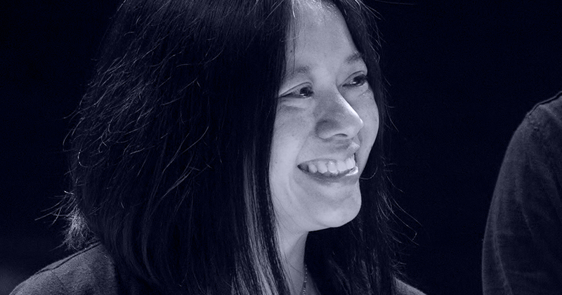 Black and white photo of composer Liza Lim smiling